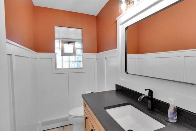 bathroom with vanity, toilet, and tile patterned flooring