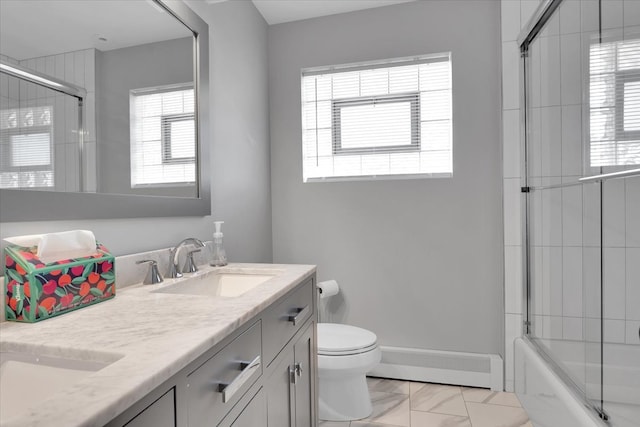 full bathroom with toilet, combined bath / shower with glass door, a healthy amount of sunlight, and vanity