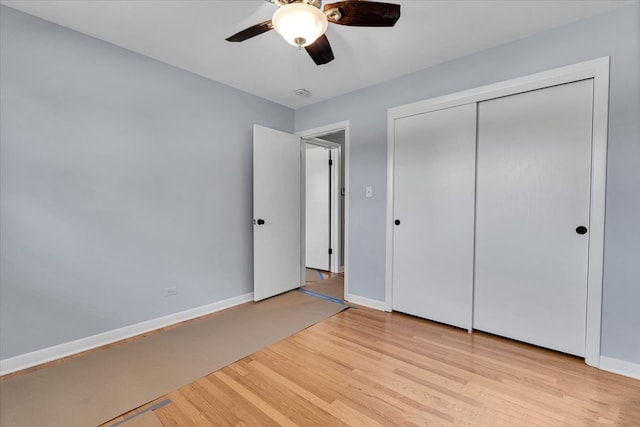 unfurnished bedroom with a closet, light wood-type flooring, and ceiling fan