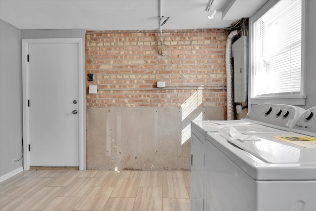 laundry area with electric panel and separate washer and dryer