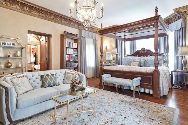 bedroom with a notable chandelier and wood finished floors