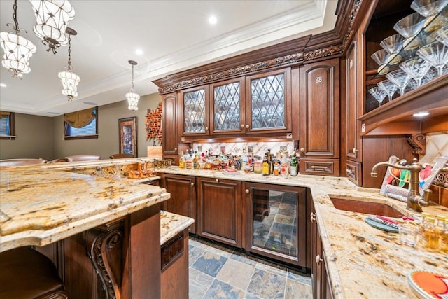 kitchen featuring stone finish flooring, light stone counters, a sink, and glass insert cabinets