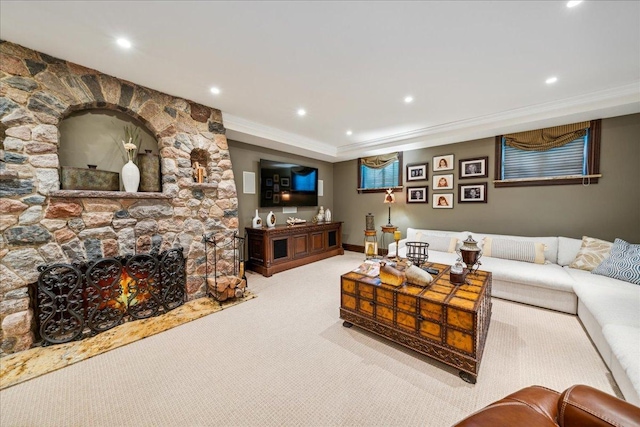 carpeted living room featuring a fireplace, crown molding, and recessed lighting