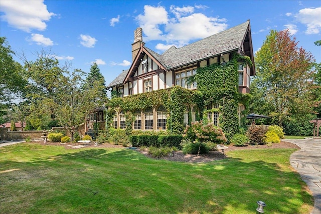 view of property exterior with a lawn and a chimney