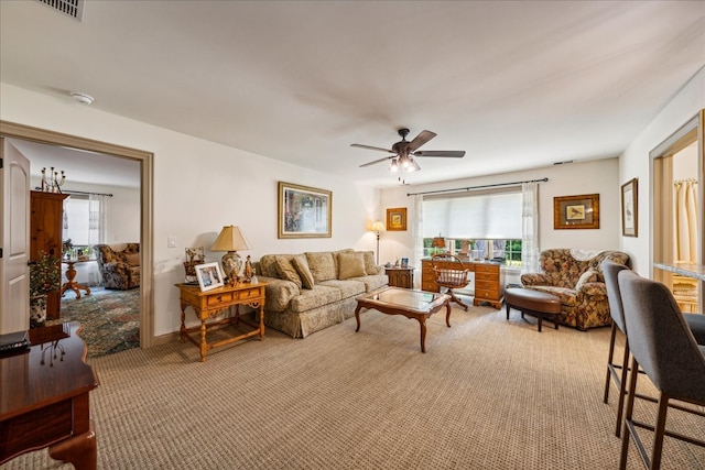 living room featuring ceiling fan, carpet floors, and visible vents