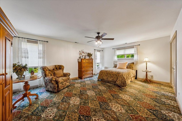 bedroom with ceiling fan and baseboards