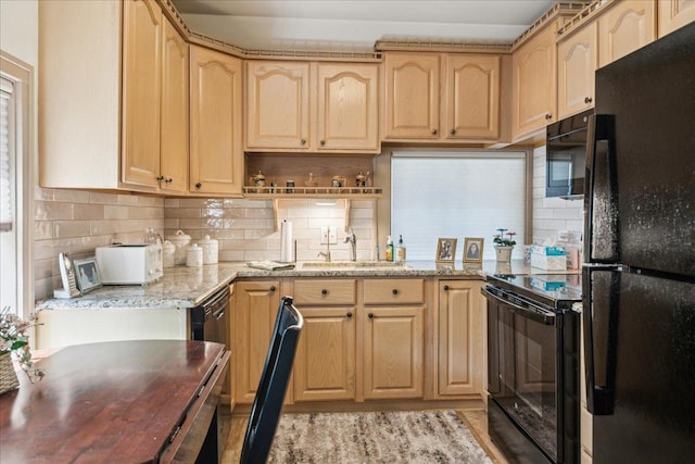 kitchen featuring tasteful backsplash, light brown cabinets, a sink, and black appliances