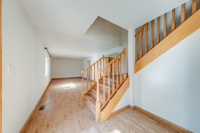 stairs featuring hardwood / wood-style floors