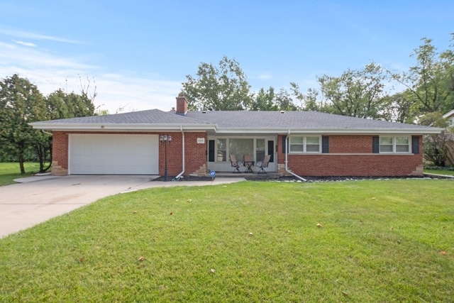 ranch-style house with a front lawn and a garage