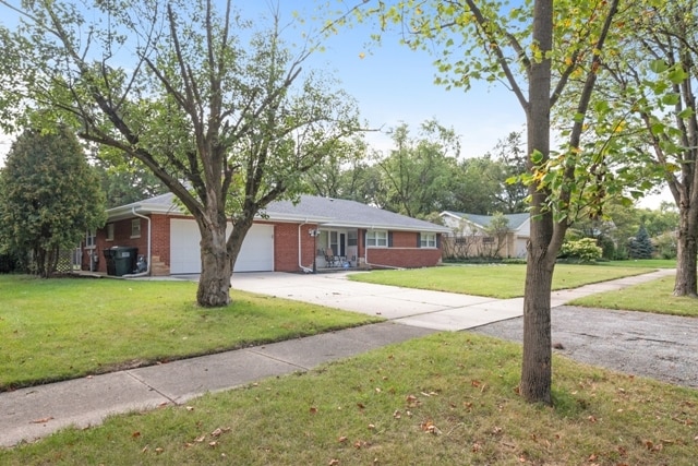 ranch-style house with a front yard and a garage