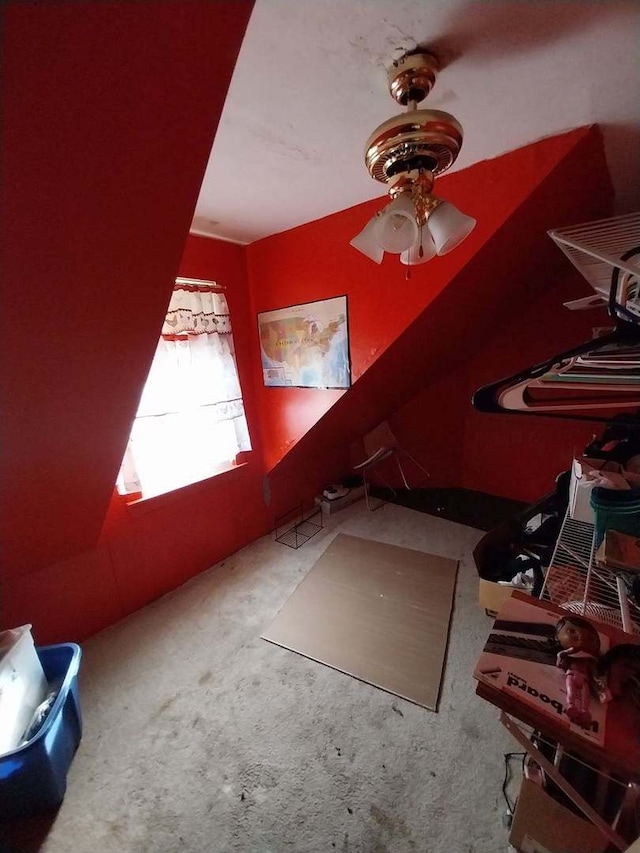 bonus room with ceiling fan and carpet flooring