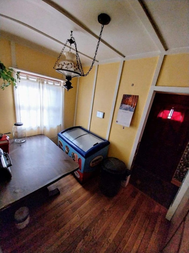 interior space with beamed ceiling and hardwood / wood-style flooring