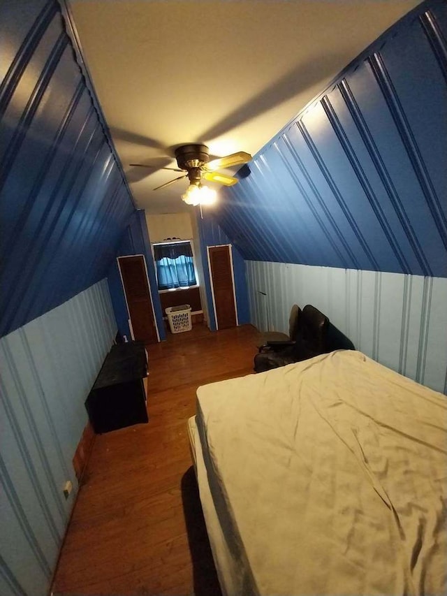 bedroom featuring ceiling fan, hardwood / wood-style floors, and vaulted ceiling