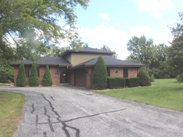 prairie-style home with a garage and a front yard