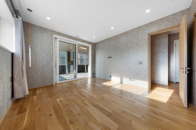 spare room featuring light hardwood / wood-style floors