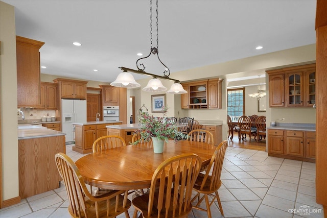 dining space featuring sink and light tile patterned flooring