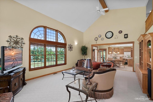 living room featuring high vaulted ceiling, ceiling fan, beamed ceiling, and light colored carpet