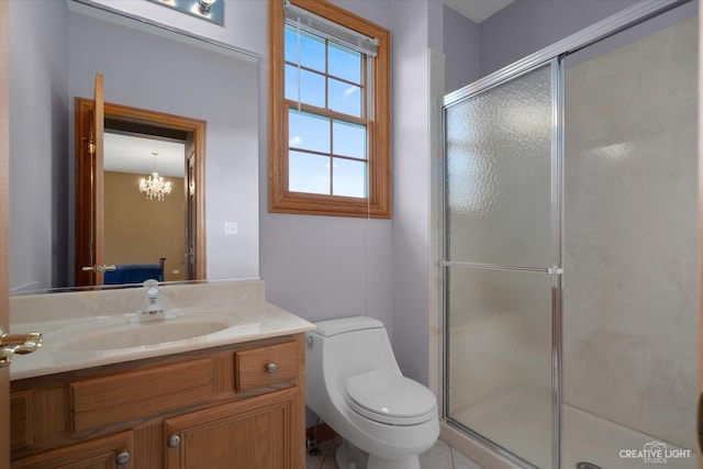 bathroom with vanity, toilet, and a shower with shower door