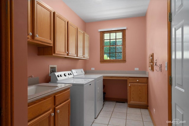 laundry area with washer and dryer, cabinets, sink, and light tile patterned flooring