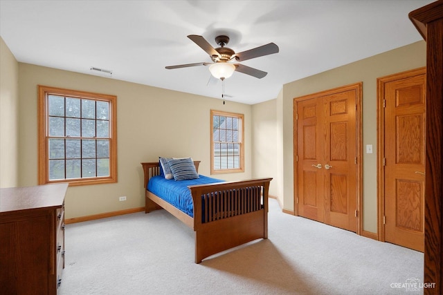 bedroom featuring light carpet and ceiling fan