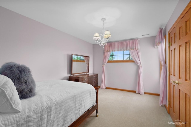 bedroom with light colored carpet and a notable chandelier