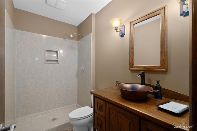 bathroom with toilet, vanity, and walk in shower