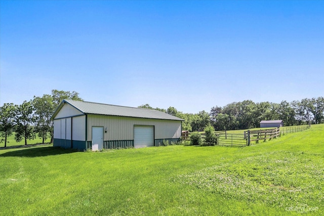 view of yard featuring an outbuilding and a garage