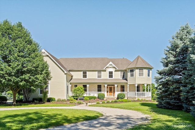 view of front of home with a front yard and a porch