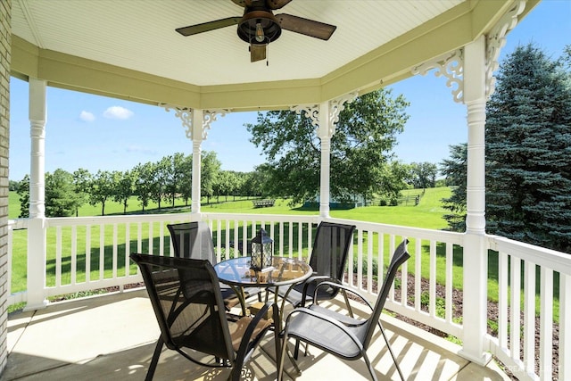 exterior space with a lawn and ceiling fan