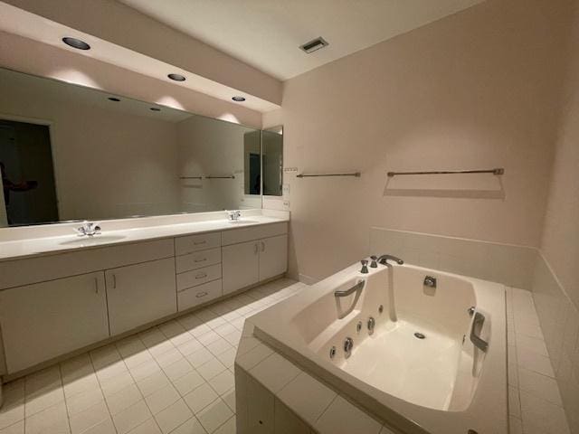 bathroom featuring tile patterned floors, vanity, and tiled tub