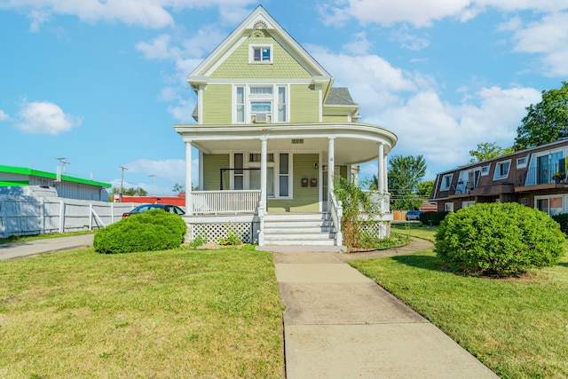 view of front of property with covered porch and a front lawn