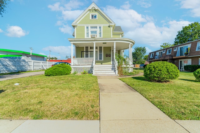 view of front of property with a porch and a front lawn