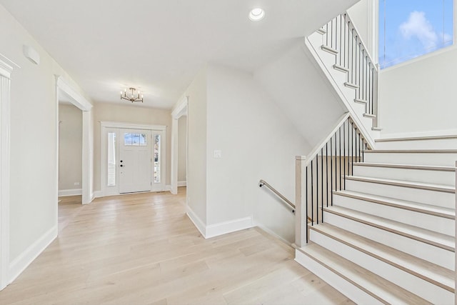 entrance foyer featuring a wealth of natural light, light wood-style flooring, and baseboards