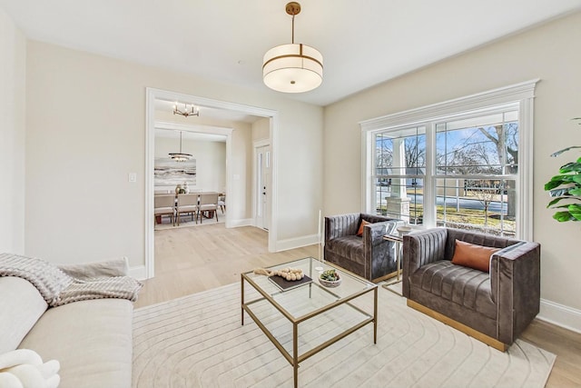 living room featuring baseboards and light wood-style floors