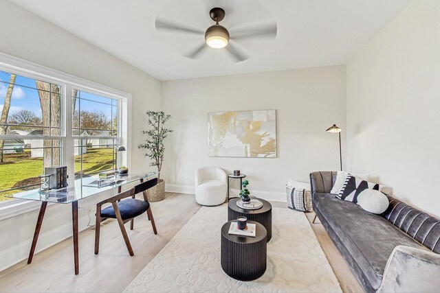 home office with light wood-style flooring, baseboards, and ceiling fan