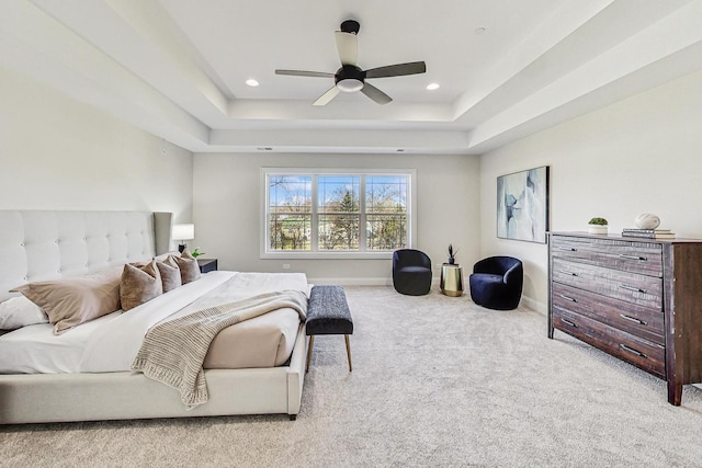 bedroom with a tray ceiling, carpet flooring, baseboards, and recessed lighting