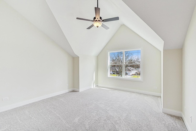 bonus room with light carpet, ceiling fan, baseboards, and vaulted ceiling