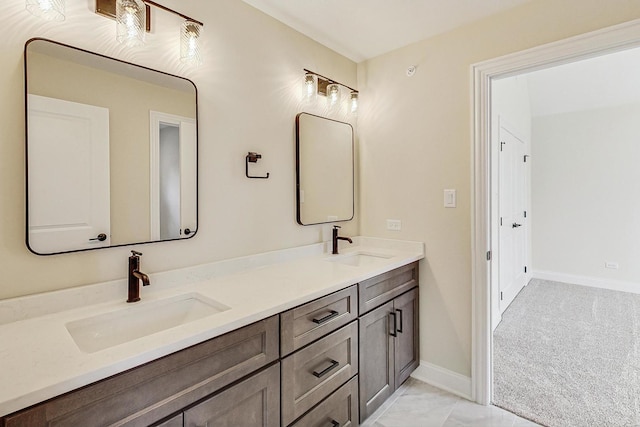 full bathroom with a sink, baseboards, and double vanity