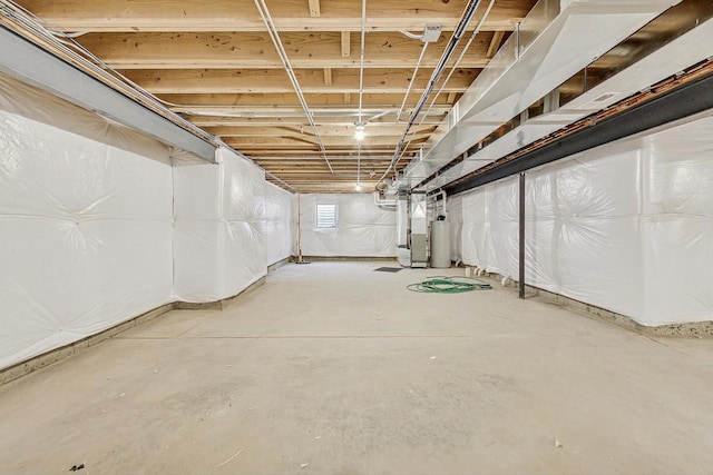 basement featuring gas water heater and heating unit