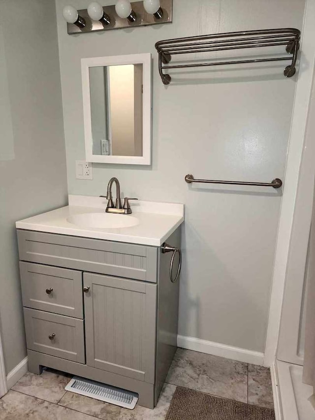 bathroom featuring tile patterned flooring and vanity