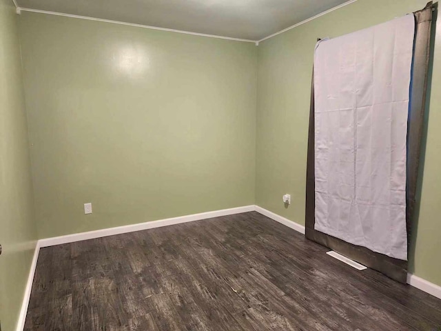 unfurnished room with crown molding and hardwood / wood-style flooring