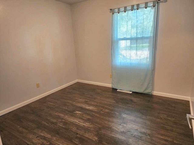 empty room with dark hardwood / wood-style floors