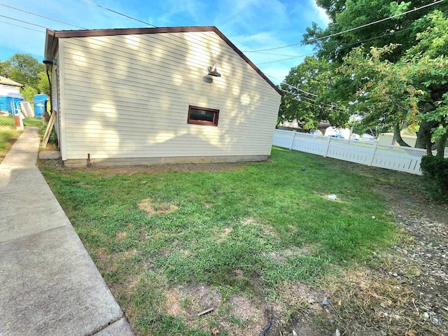 view of side of property with a yard