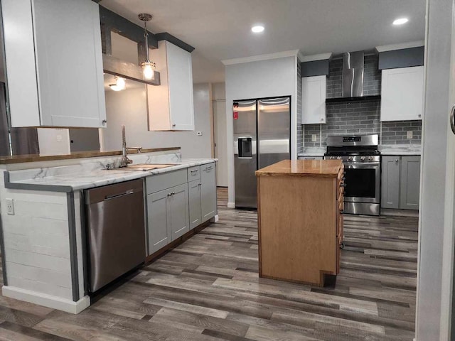 kitchen with stainless steel appliances, wall chimney range hood, dark hardwood / wood-style floors, and hanging light fixtures