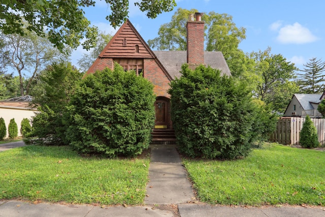 tudor-style house with a front yard