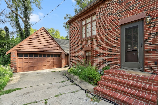 exterior space featuring a garage and an outbuilding