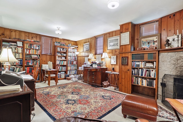 carpeted home office with wood walls