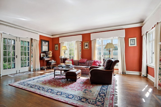 living room featuring hardwood / wood-style floors, crown molding, and french doors