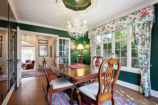 dining space with a notable chandelier, dark hardwood / wood-style floors, and crown molding