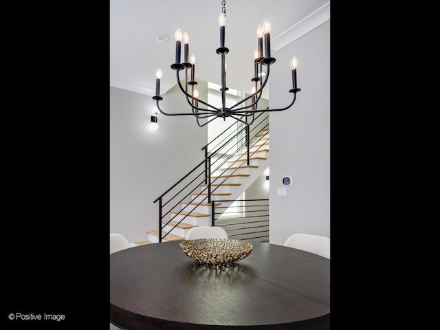 dining space featuring crown molding and a notable chandelier